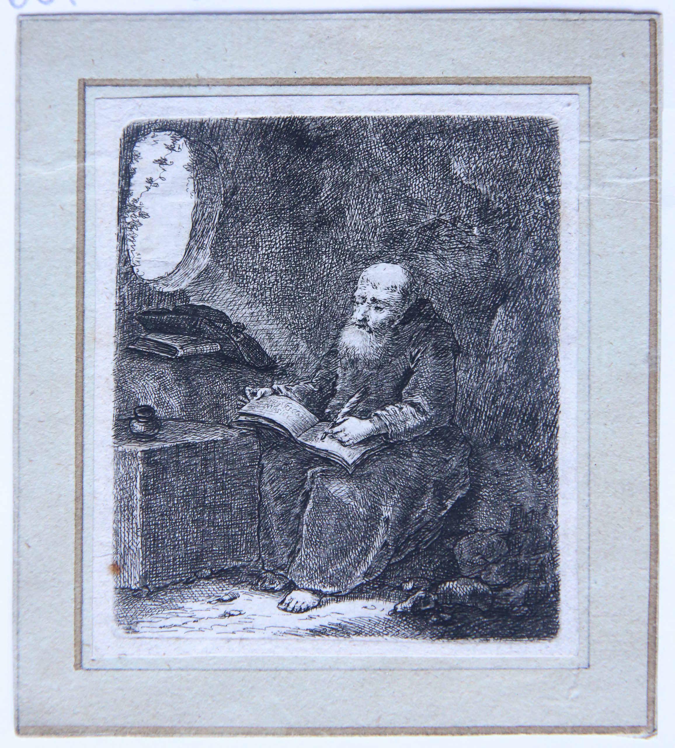 Etching/Ets: A hermit writing on a book (een kluizenaar schrijft een boek).