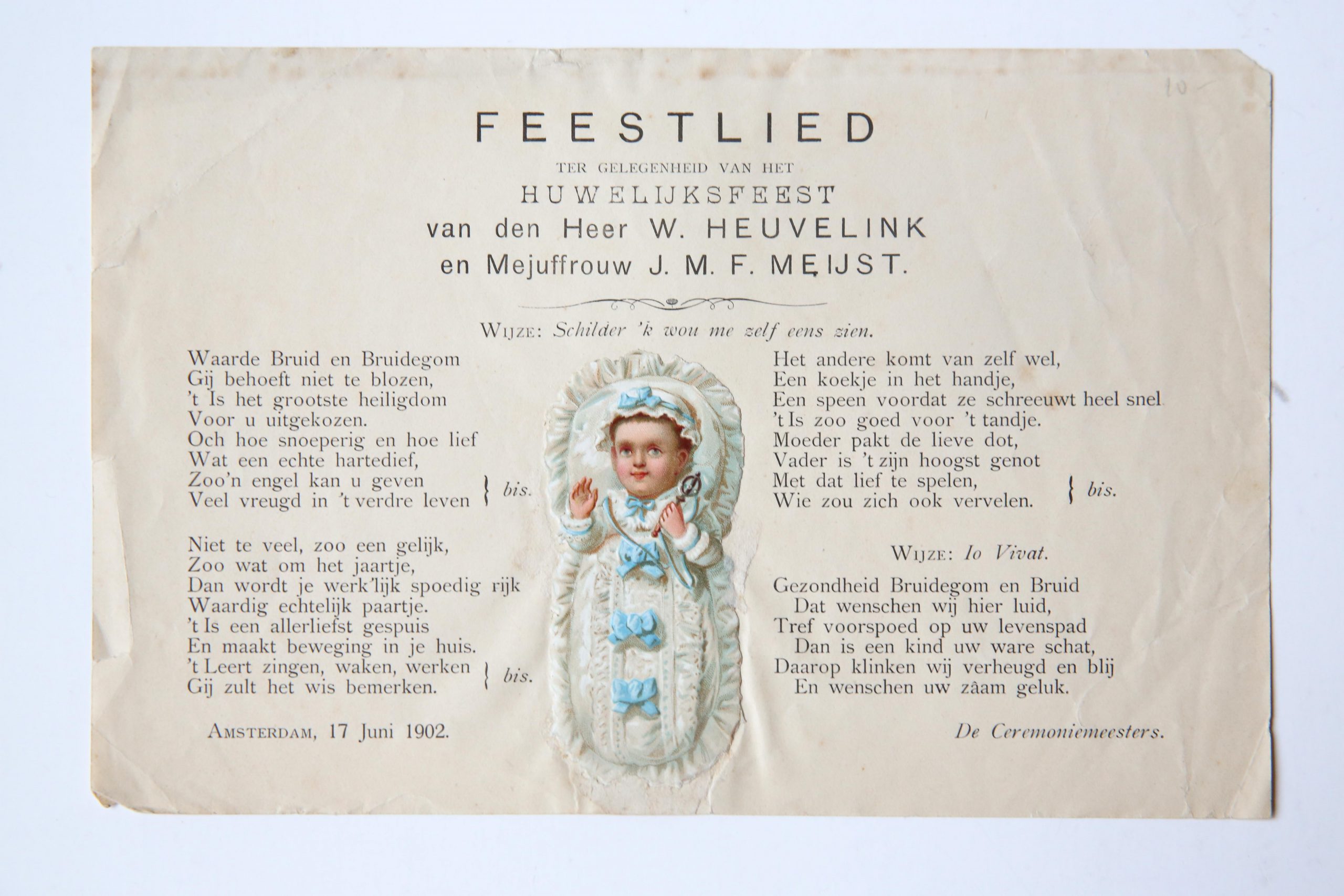  - Feestlied ter gelegenheid van het huwelijksfeest van den heer W. Heuvelink en mejuffrouw J.M.F. Meyst. Amsterdam, 17 juni 1902. 8 oblong: 1 blz. Met opgeplakt plaatje van baby.
